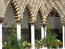 Multifoil arches in the Mudéjar Patio de las Doncellas at the Alcazar of Seville in Spain (14th century)